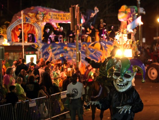 The 460 riders of the satirical Krewe D'Etat turn onto St. Charles Avenue as they roll down the traditional Uptown route with their 22-float presentation entitled "The Dictator's Reading Room" Friday, Feb. 8, 2013 in New Orleans. (AP Photo/The Times-Picayune, Michael DeMocker) MAGS OUT; NO SALES; USA TODAY OUT; THE BATON ROUGE ADVOCATE OUT