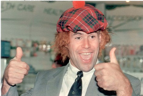 Oops Tartan joker in the pack Kenny Logan created airport mayhem yesterday as Scotland's squad flew off to the rugby World Cup in South Africa.